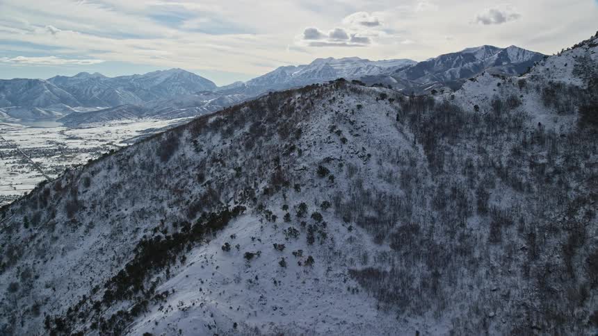 Aerial view of the snow covered slopes of a mountain range