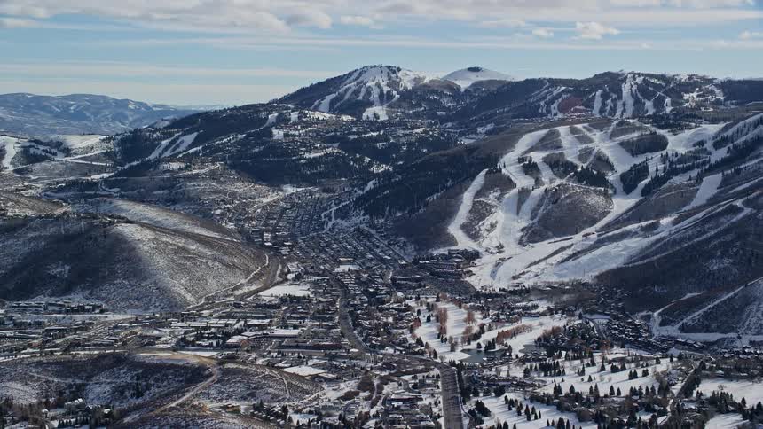 Aerial view of a town surrounded by snowy mountains