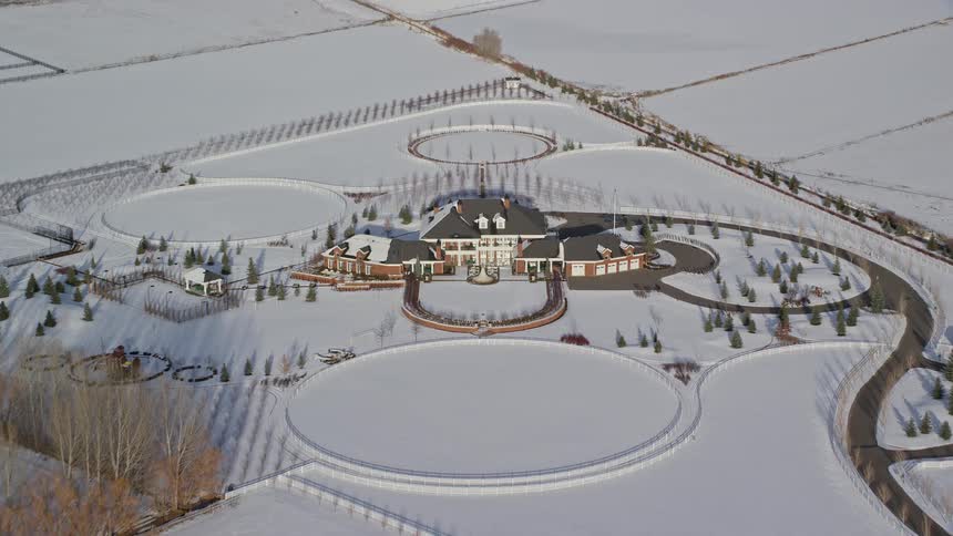 Aerial panorama of a mansion in the middle of a snowcovered field