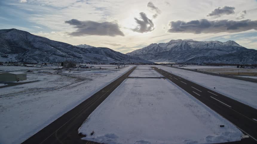 Panorama of an airport runway with snowcovered fields on a morning