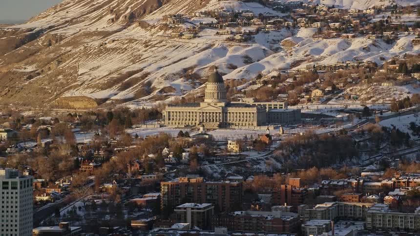 Aerial panorama of a metropolis through the hills of snowcovered mountains