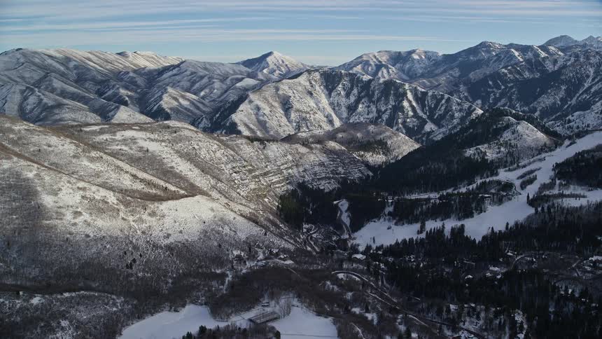 Panorama of a mountain range with snowcovered conifers on a morning