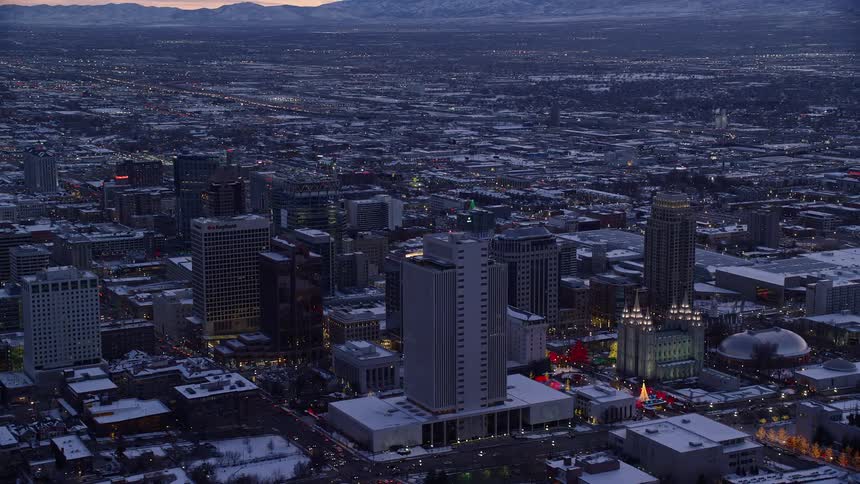 Aerial view of a citys downtown area glowing with illumination in the evening