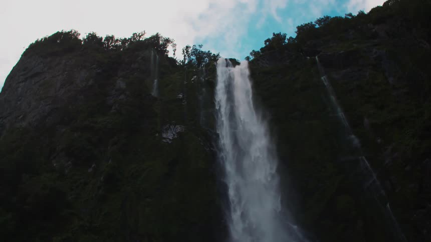 The waterfall is pouring off the cliff