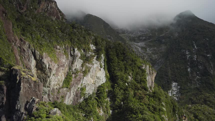 Clouds sit on the top of the green mountains