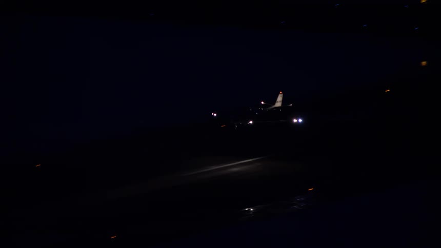 Panorama of an airplane landing at night