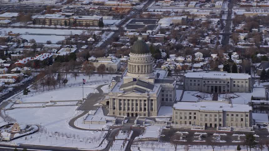 An office building with a dome on top in a snowy city