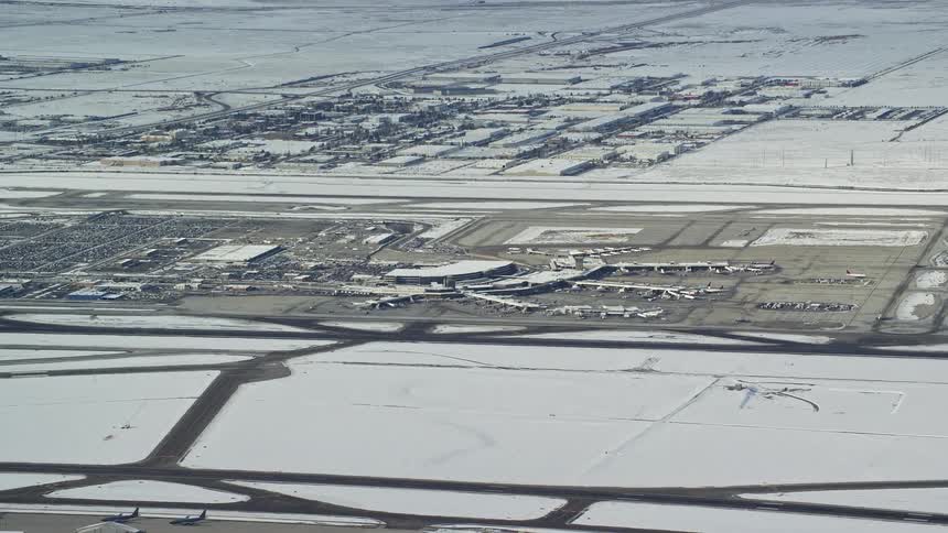 Skyline of an airport with snowfall during the day
