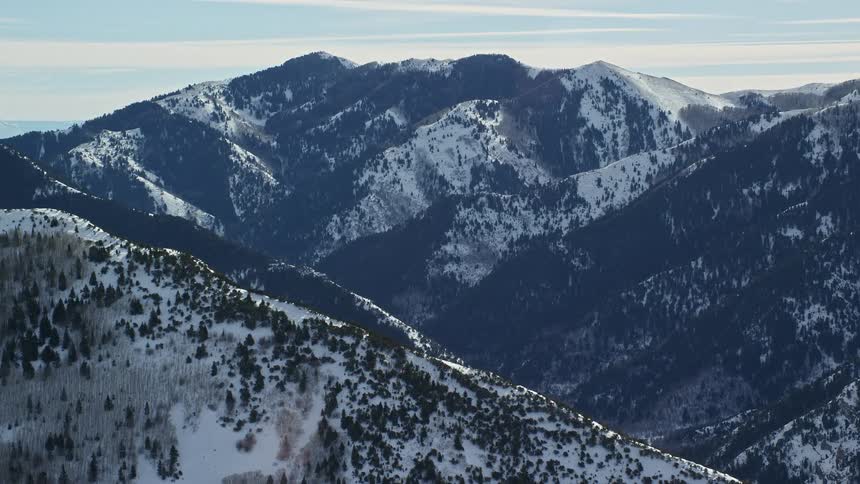 Peak of mountains covered in snow at midday