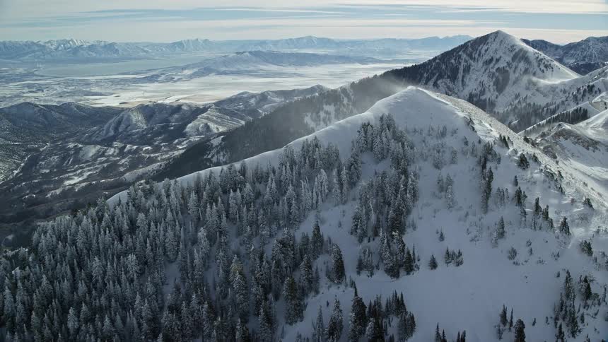 An aerial view of a snowcovered mountain peak