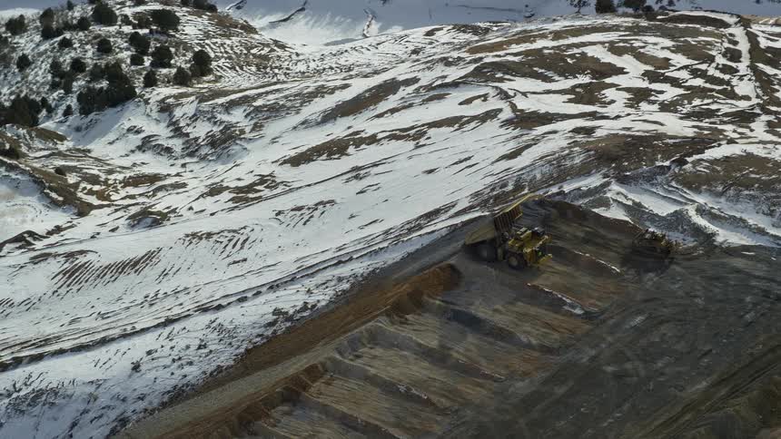 A dump truck is driving on the mountain top