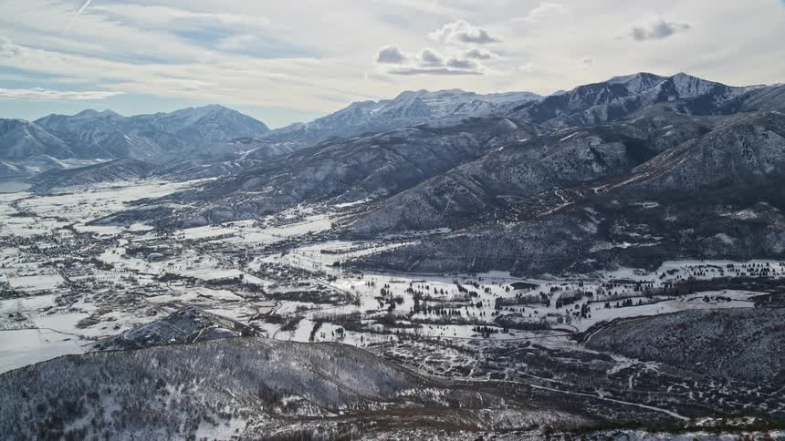 Aerial of a valley with snowcovered mountains during winter
