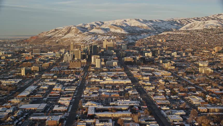 Aerial view of cityscape with snowy mountains in the background