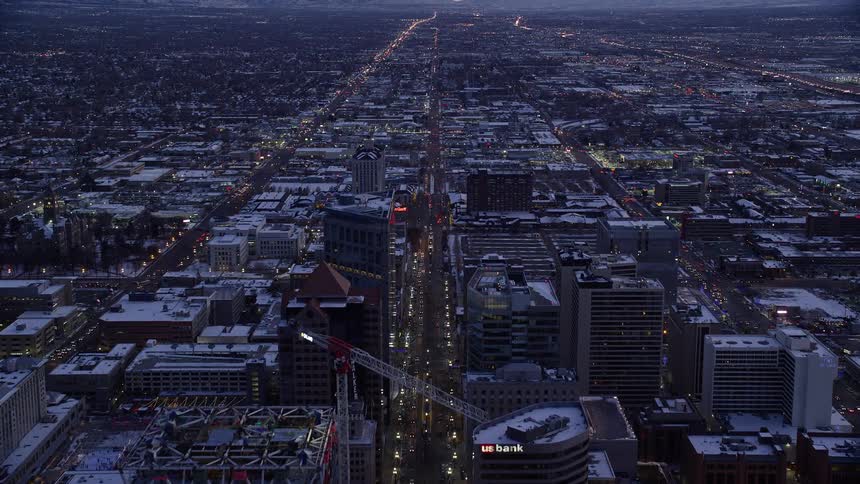 Large city with several illuminated buildings at dawn