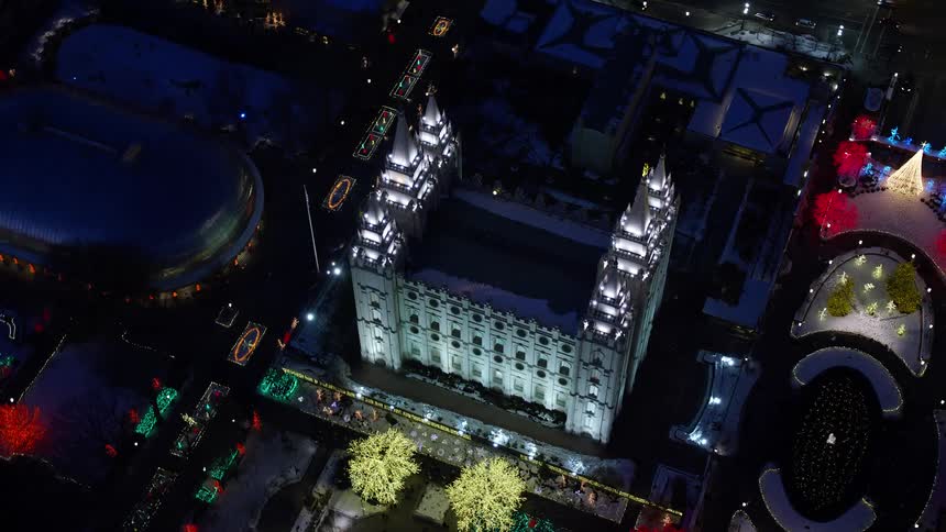 Aerial view of a church amidst the city with illuminated trees at night