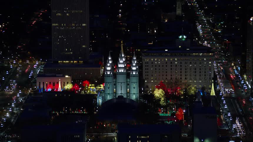 A large cathedral within a city illuminated at night