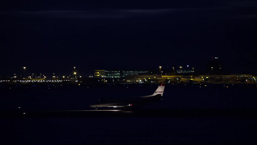 Airplane slowing down on the runway at night