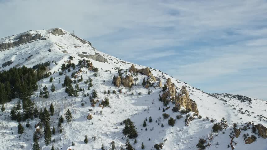 Peak of mountains covered in snow during the day