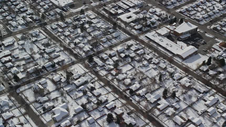 Aerial panorama of a residential neighborhood covered in snow