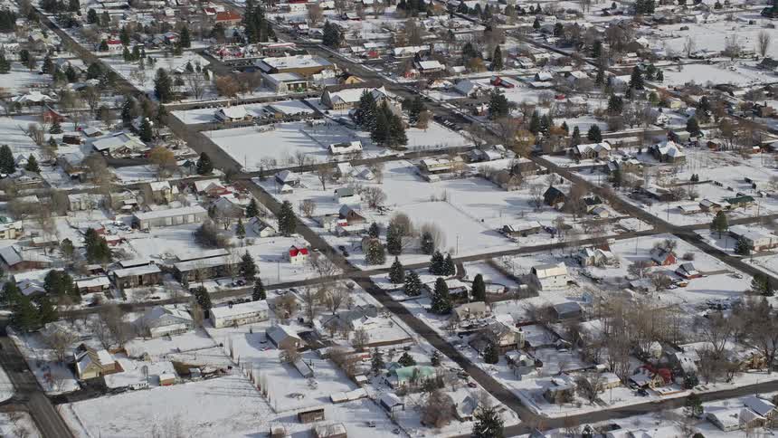An aerial view of a small town with lots of snow on the ground