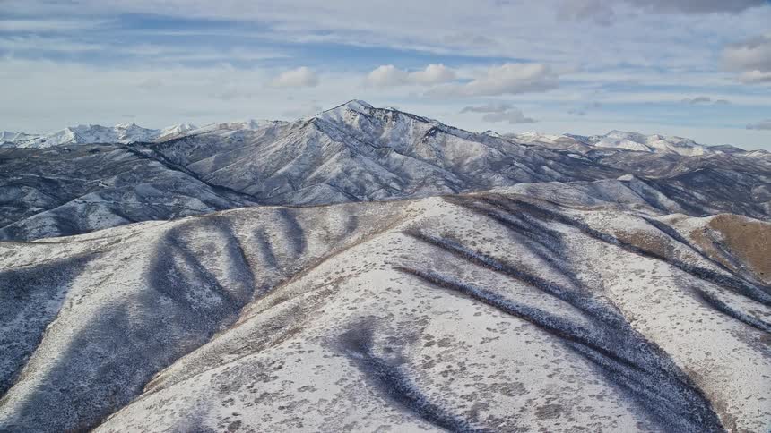 Aerial view of the snowy slopes on a mountain range