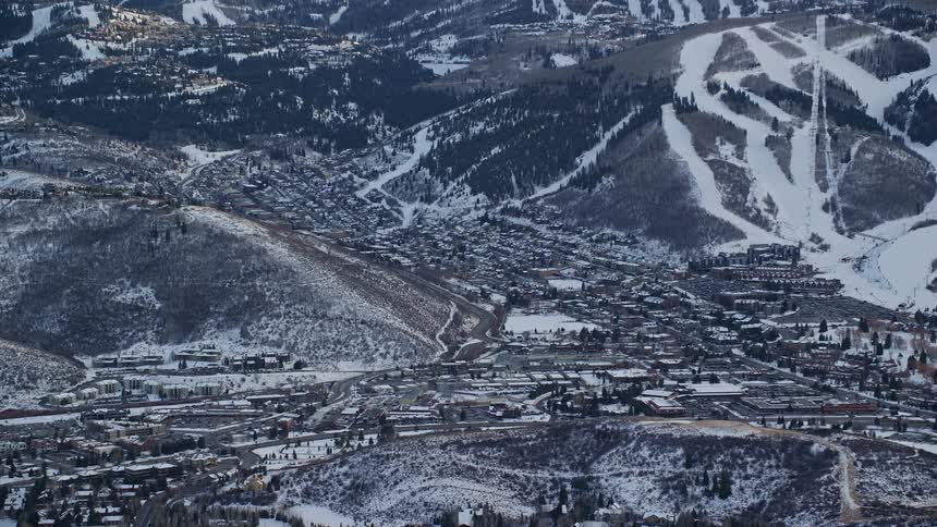 Aerial of park city mountain resort in utah with snow on the ground and ski slopes on a bright day