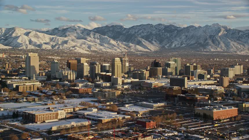 An urban city with snow on buildings during the day
