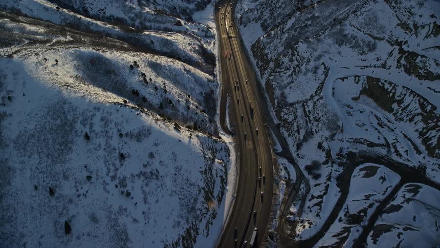 Traffic runs on the highway between the mountains
