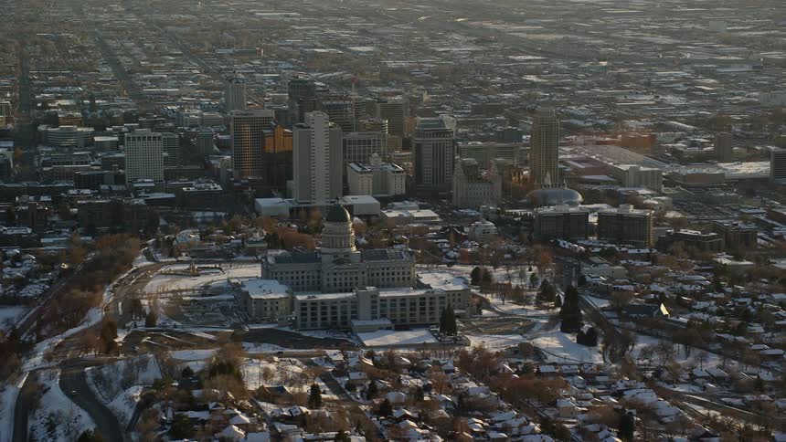 Panorama of a snowcovered metropolis with the sunrise reflecting on the buildings