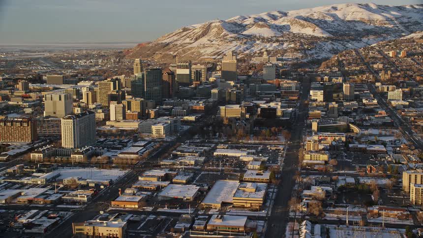 Skyline of a snowy city during sunrise