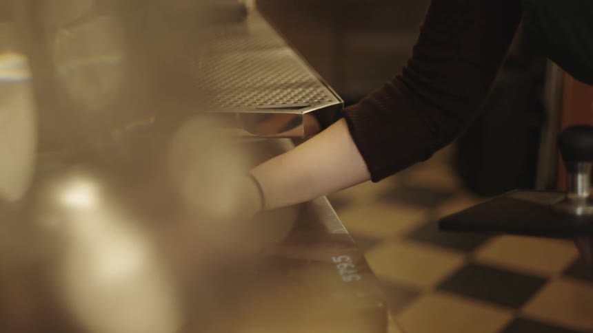 A person cleaning a bar counter