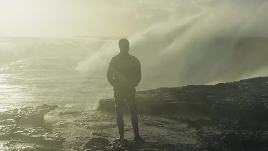 A man standing by the beach side during the day
