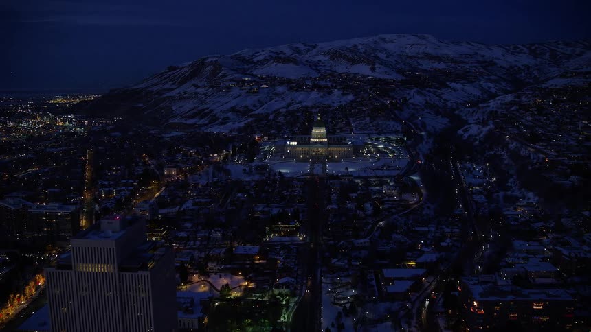 Aerial of an illuminated urban city at night during winter