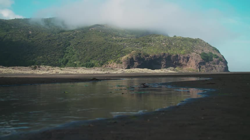 A desert island with mountains during the day