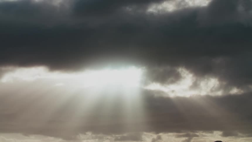 Sunlight rays filter through the clouds