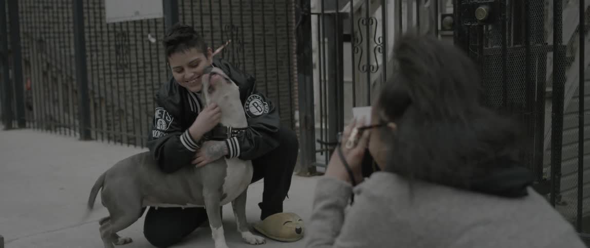 A woman is photographed petting her dog
