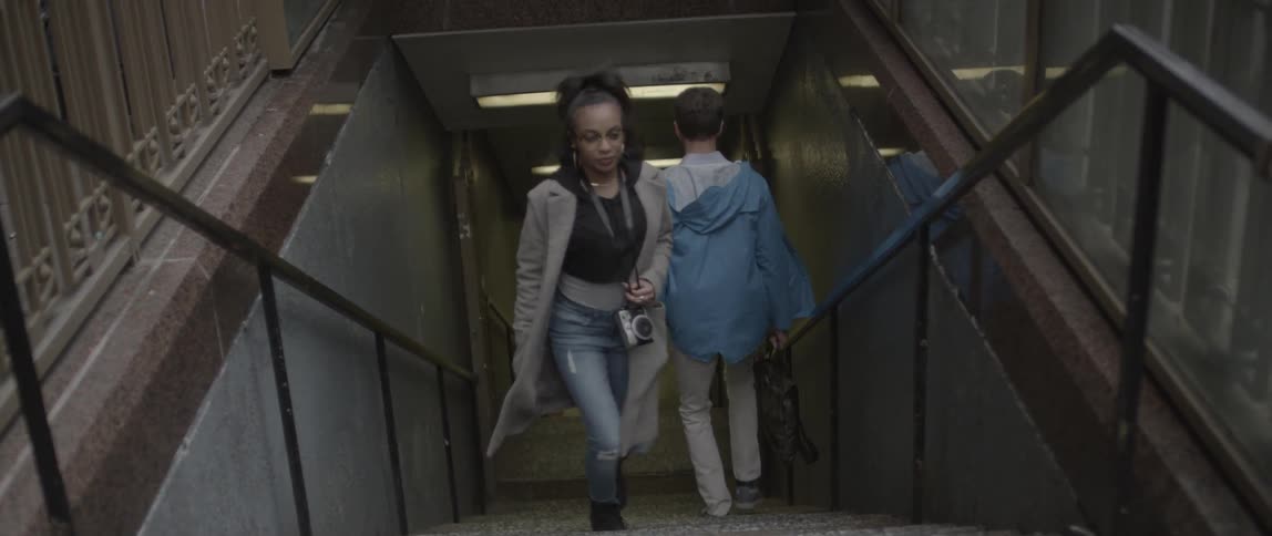 People are walking up and down a subway staircase
