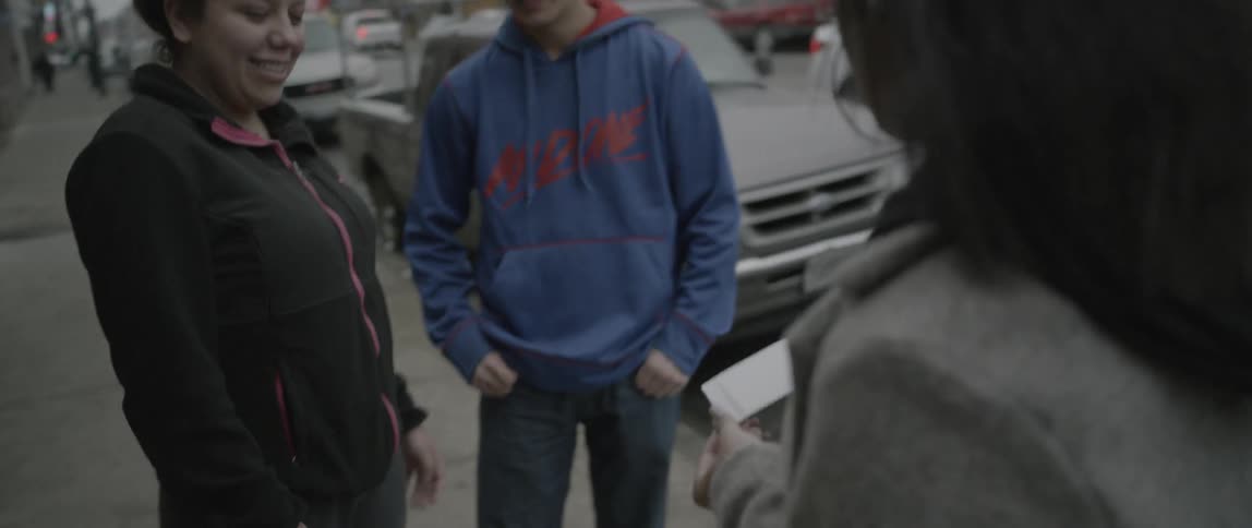 A group of people talking outside