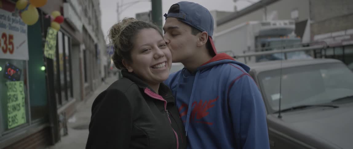 A man kisses a woman on the cheek