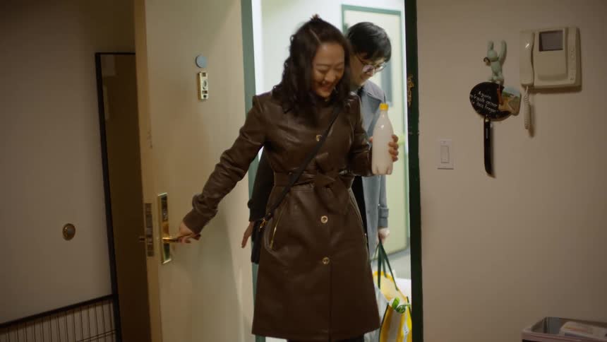 Couple arriving home and the dog welcoming them