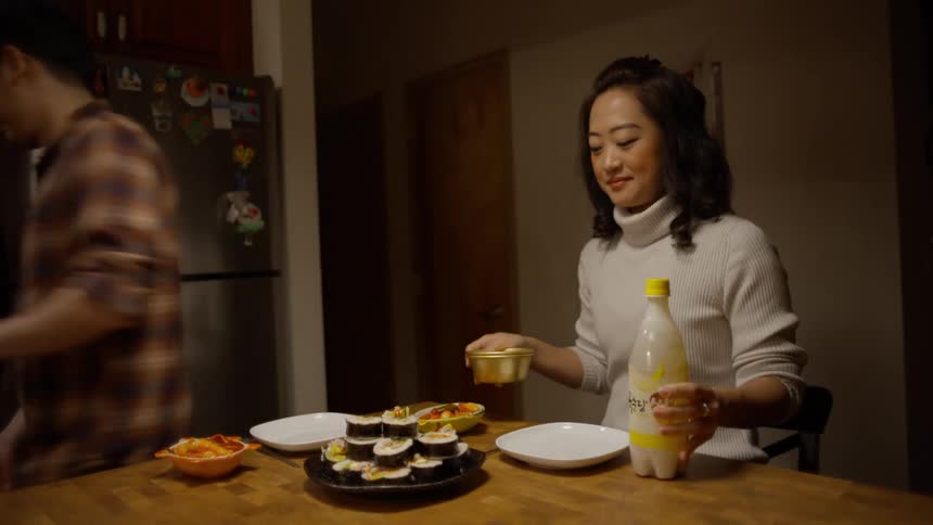 Couple getting ready to sit at the table and start eating Korean food