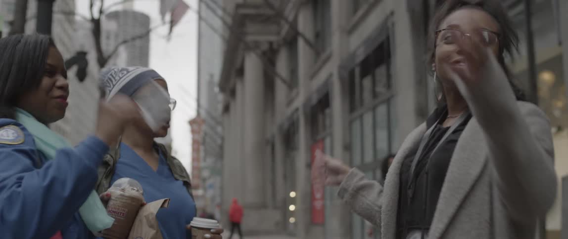 Women talk together on a city street