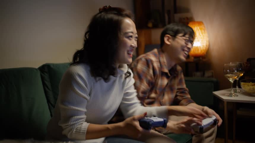 A man and woman play video games together
