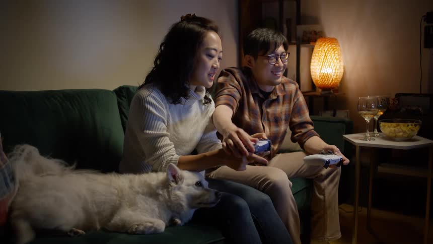 A man and a woman having fun playing video games