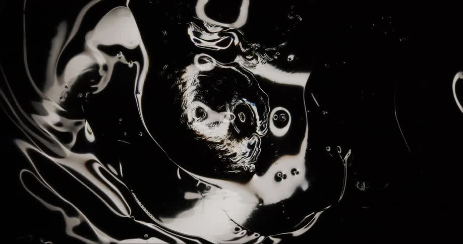 A liquid with black color and white reflections