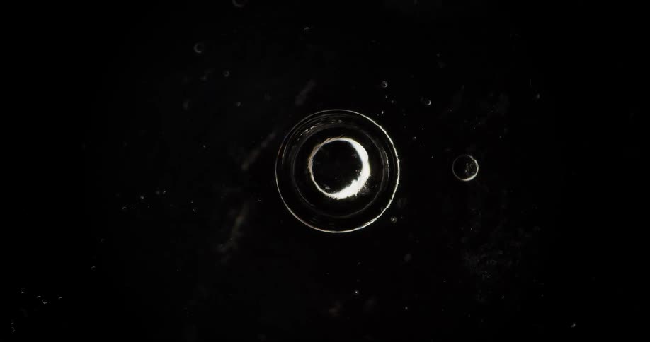 A thin transparent circle rotates against a black background