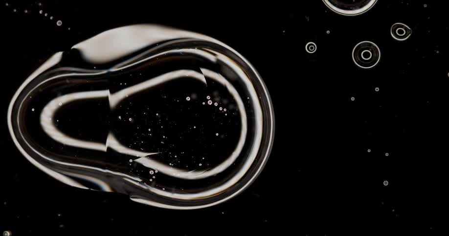 Extreme close up on water bubbles attaching to each other
