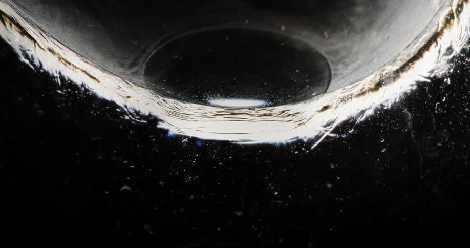 Extreme closeup of liquid entering a bubble in slow motion