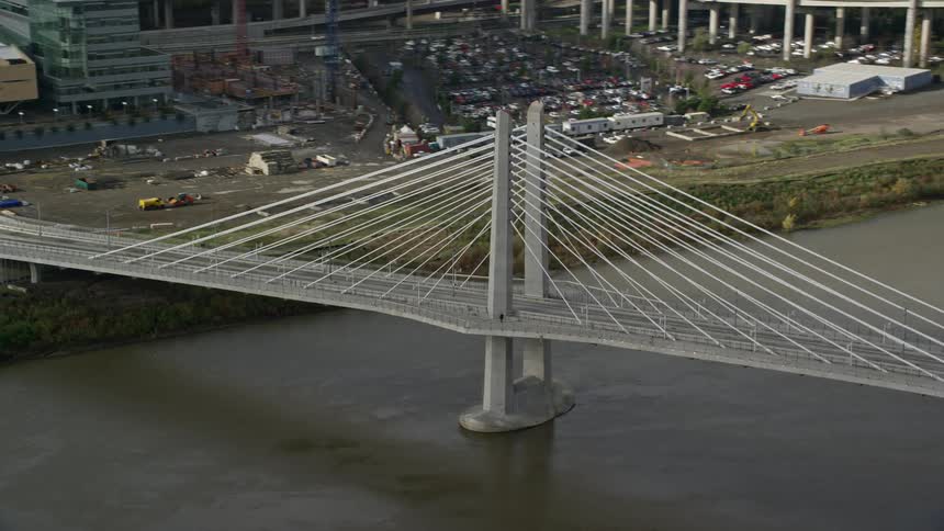 Aerial view of a bridge over the river amidst the city