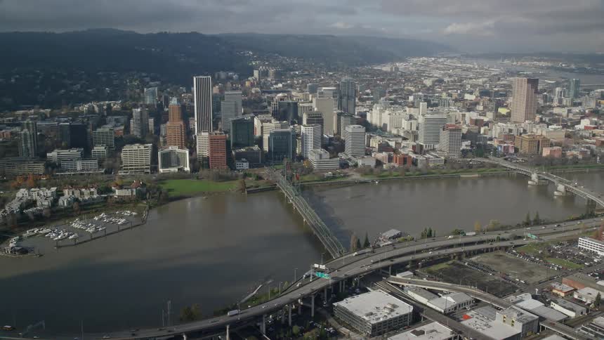 Skyline of a big city with skyscrapers and waterways during cloudy day